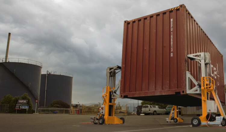 shipping container lifted with bison jacks