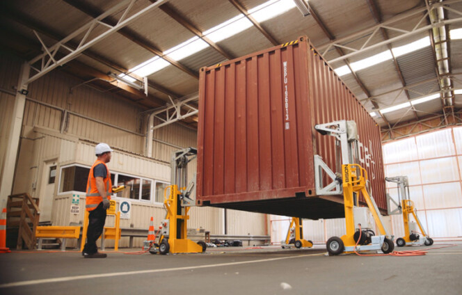 Bison A Series jacks lifting a shipping container