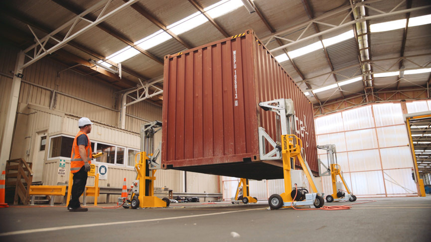 Bison A Series jacks lifting a shipping container